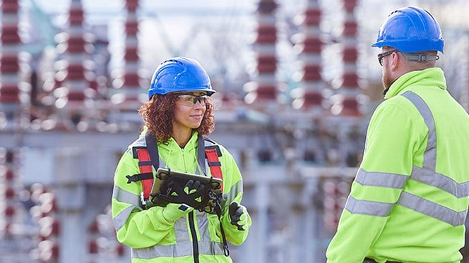Utility engineers using AI-driven predictive analytics to monitor power generation assets