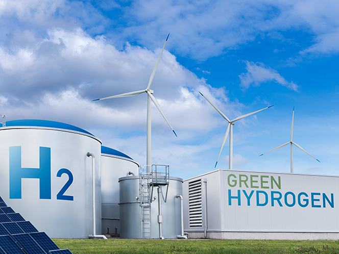 Green hydrogen facility with wind turbines and storage tanks, symbolizing the transition from pilot projects to scalable, profitable clean energy production.