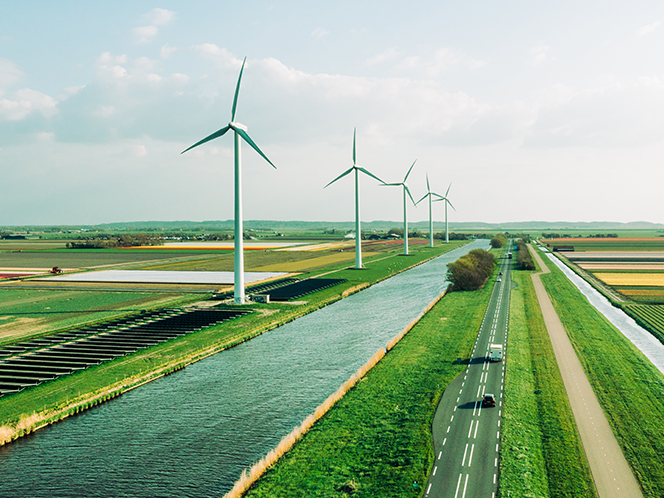 wind turbines beside a highway